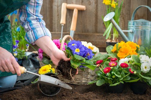 Trainer demonstrating safe tool operation to gardeners during staff training